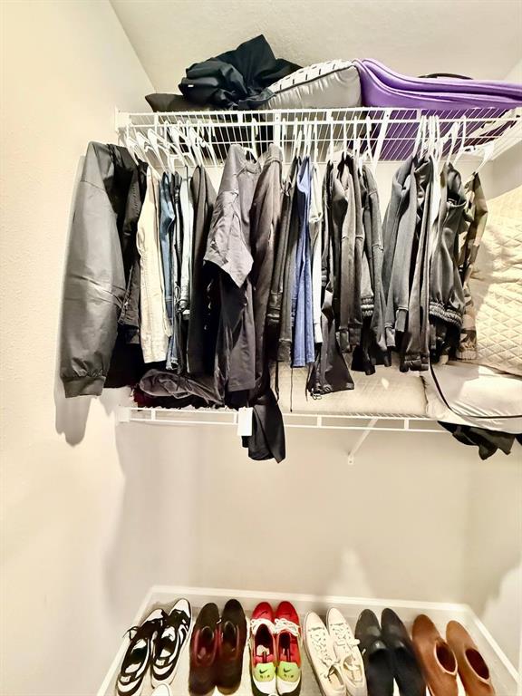 8319 Wildflower Glen Avenue Odessa, FL 33556 - Photo 29 of 34 a view of walk in closet with clothes and shoes