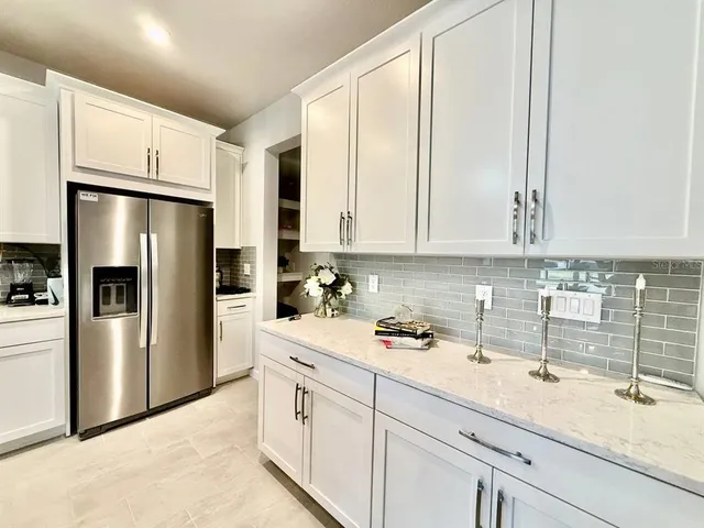 a kitchen with a sink and refrigerator