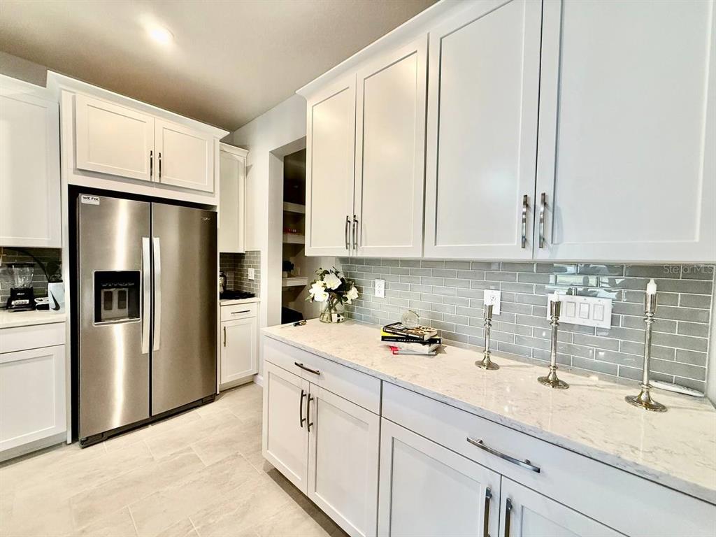 8319 Wildflower Glen Avenue Odessa, FL 33556 - Photo 8 of 34 a kitchen with a sink and refrigerator