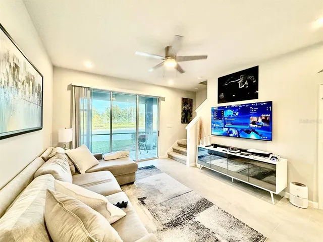 a bedroom with furniture and a flat screen tv
