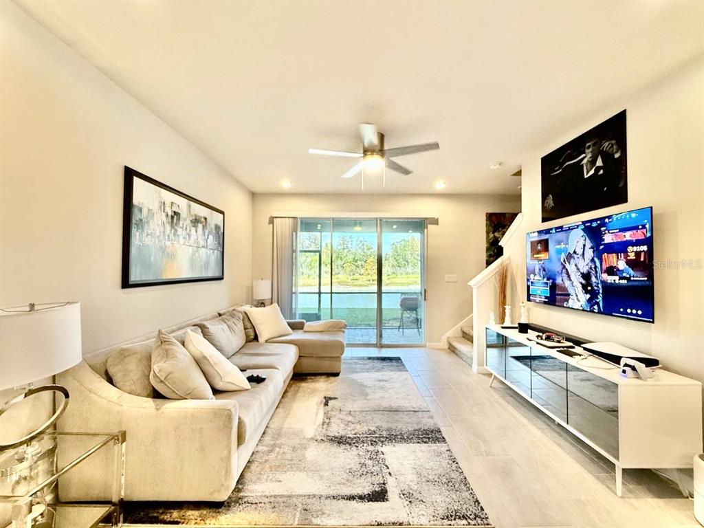 8319 Wildflower Glen Avenue Odessa, FL 33556 - Photo 10 of 34 a living room with furniture and a flat screen tv