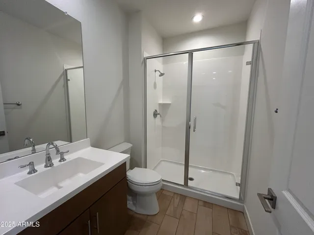a bathroom with a sink toilet and shower