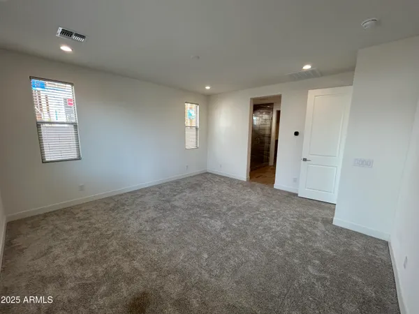 an empty room with windows and closet