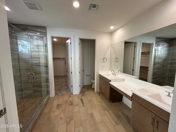 a large bathroom with a double vanity sink and mirror