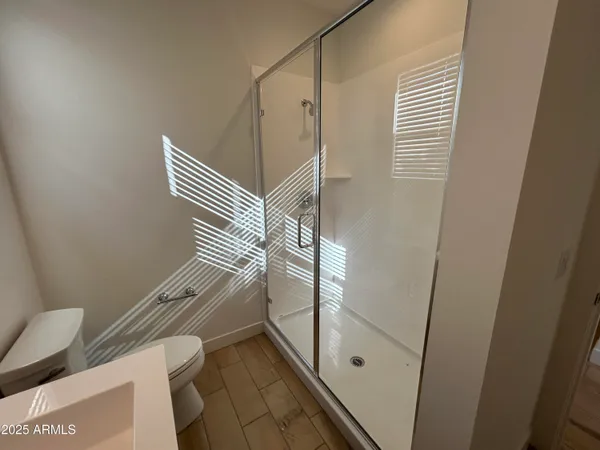 a bathroom with a shower and toilet