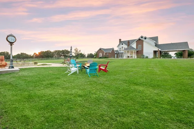 a kitchen with stainless steel appliances granite countertop a sink and a refrigerator