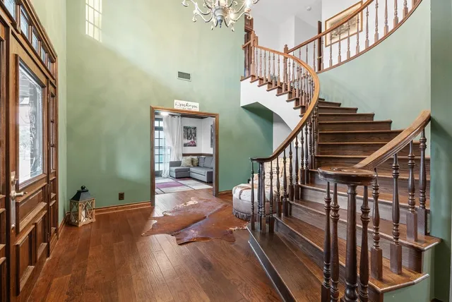 a bedroom with a large bed a couch and potted plant