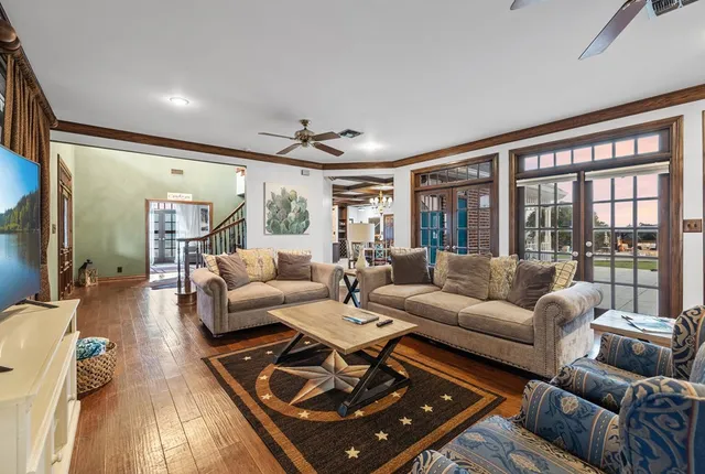 a bedroom with a bed and a large window with the balcony view