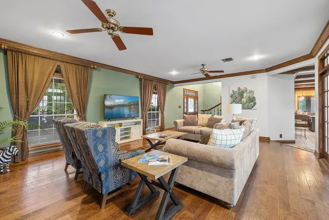 a view of a dining room with furniture large windows and wooden floor