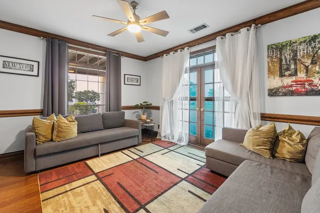 a front view of a house with a yard and trees