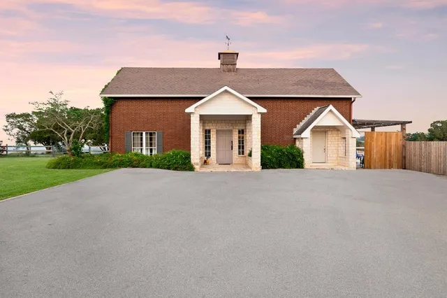 a bathroom with a sink a toilet a mirror and shower curtain