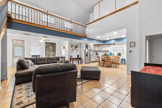an aerial view of residential houses with outdoor space and trees