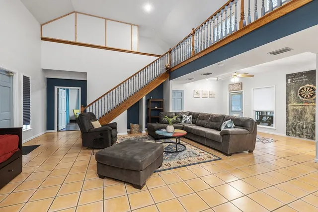 an aerial view of a house with a garden and lake view