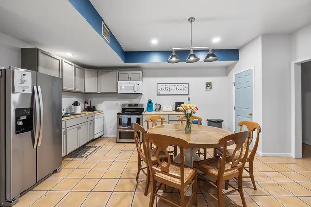 an aerial view of residential houses with outdoor space and trees