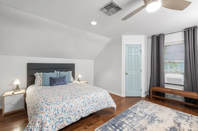 an aerial view of residential houses with outdoor space and trees