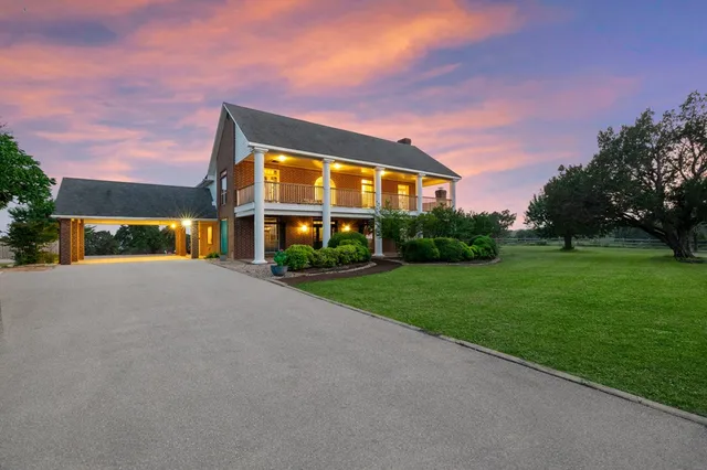 a view of a backyard with plants and wooden fence