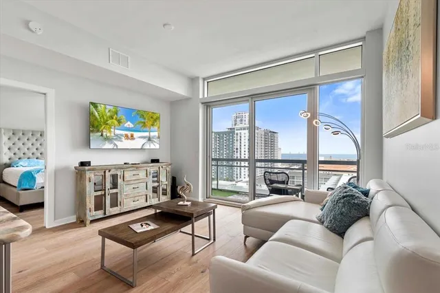 a living room with furniture windows and a flat screen tv