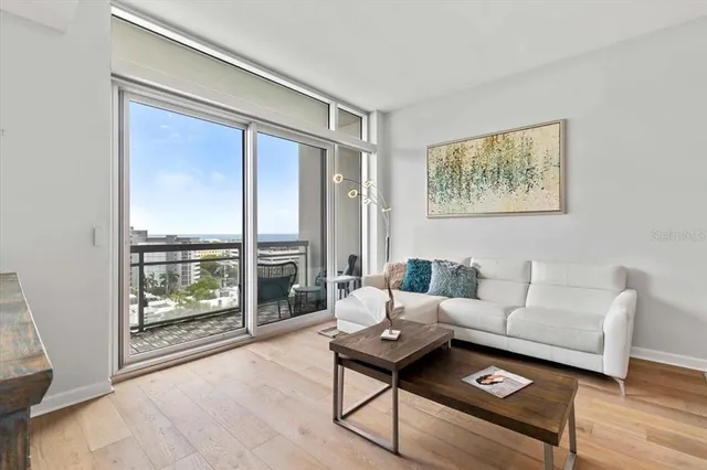 a living room with furniture and a floor to ceiling window