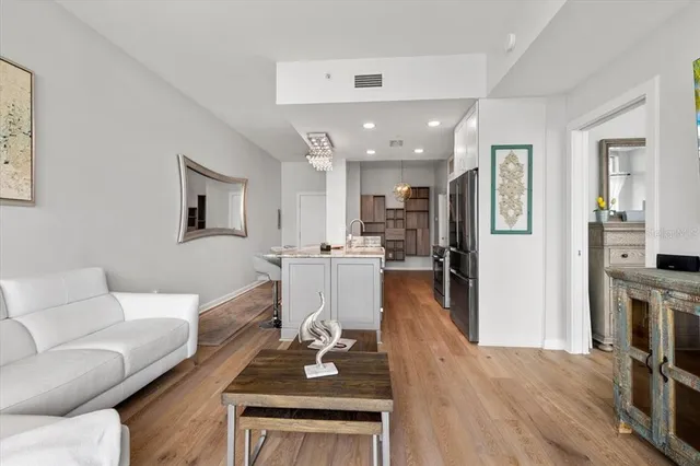 a living room with furniture and a wooden floor
