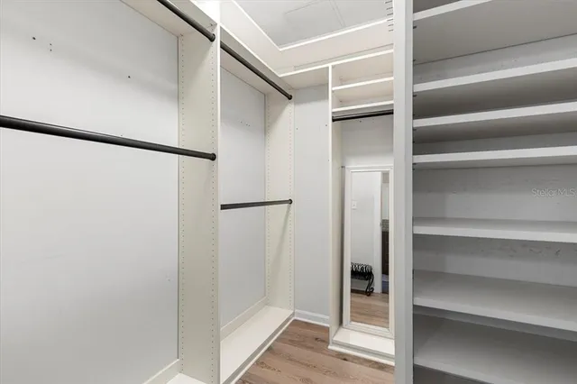 a view of walk in closet with empty racks