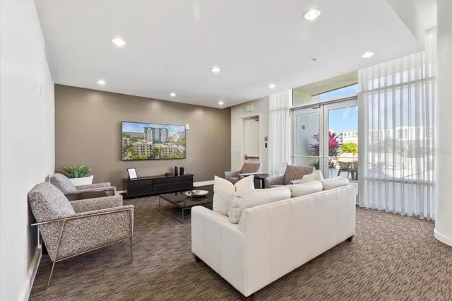 a living room with furniture and a large window