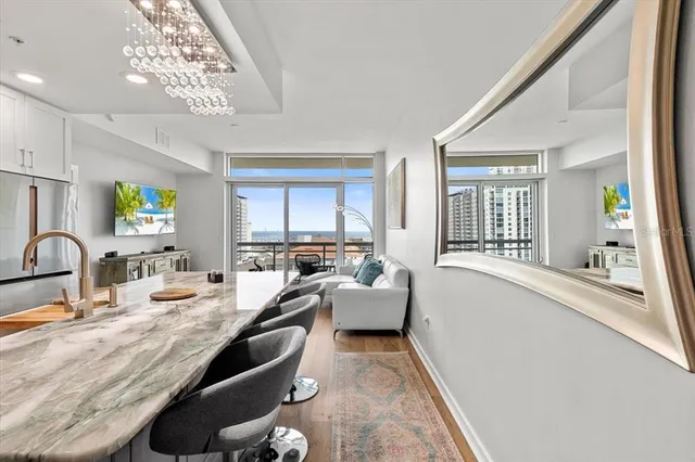 a large white kitchen with a large window