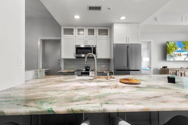 a kitchen with stainless steel appliances a sink and a refrigerator