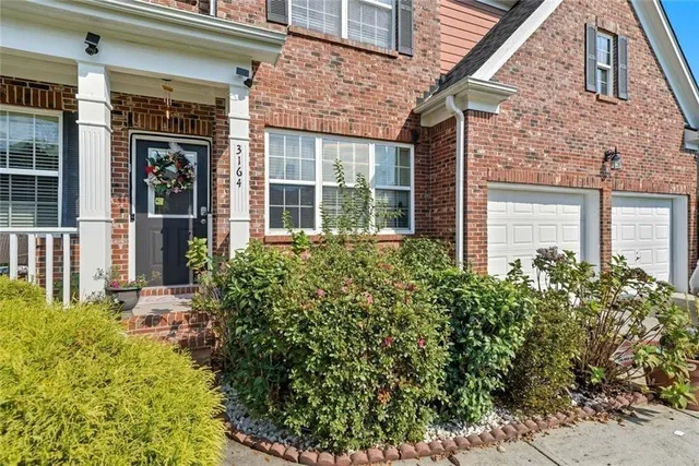 front view of a brick house with a large window