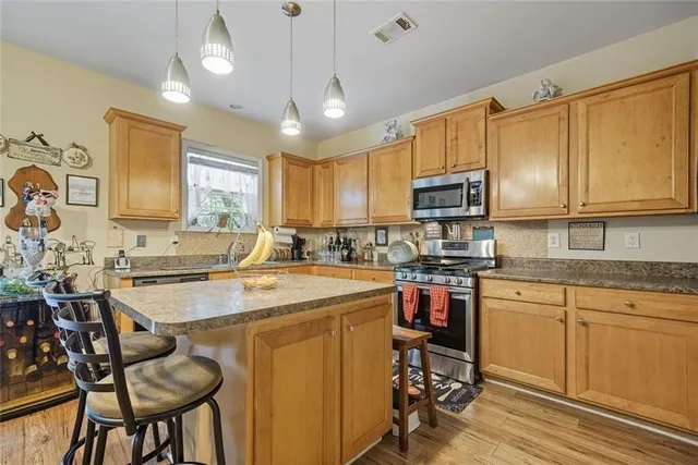 a living room with furniture a flat screen tv and a large window