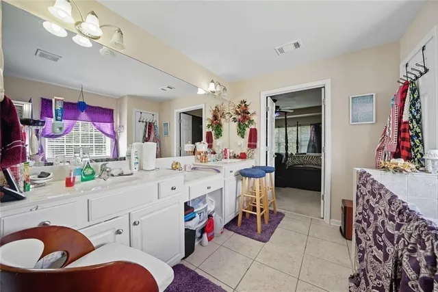 a living room with furniture a flat screen tv and a large window