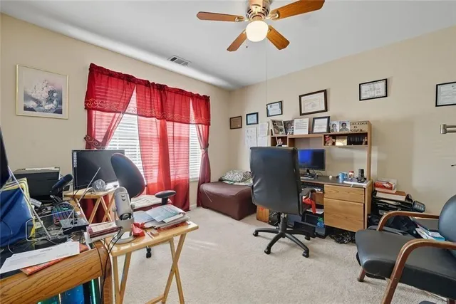 a living room with furniture a flat screen tv and kitchen view