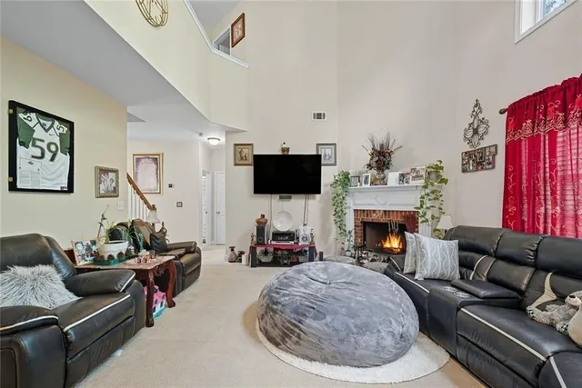 a kitchen with stainless steel appliances granite countertop a stove top oven a sink dishwasher a dining table and chairs with wooden floor