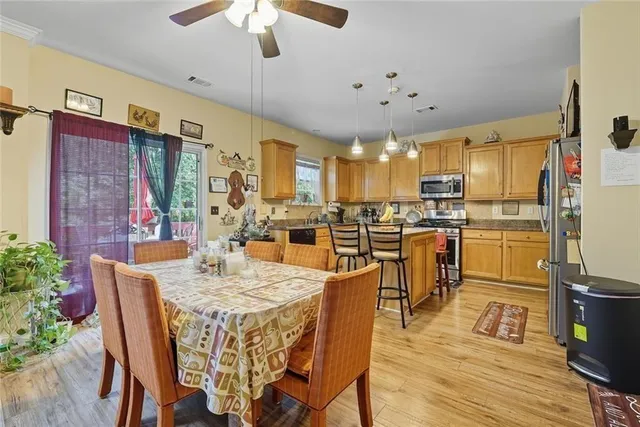 a large kitchen with a table and chairs