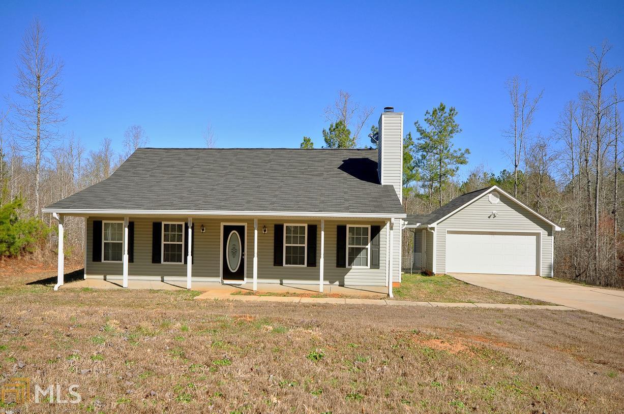 321 Polk Road, Unit 5 Moreland, GA 30259 - Photo 1 of 1 a view of a white house with large windows and a small yard