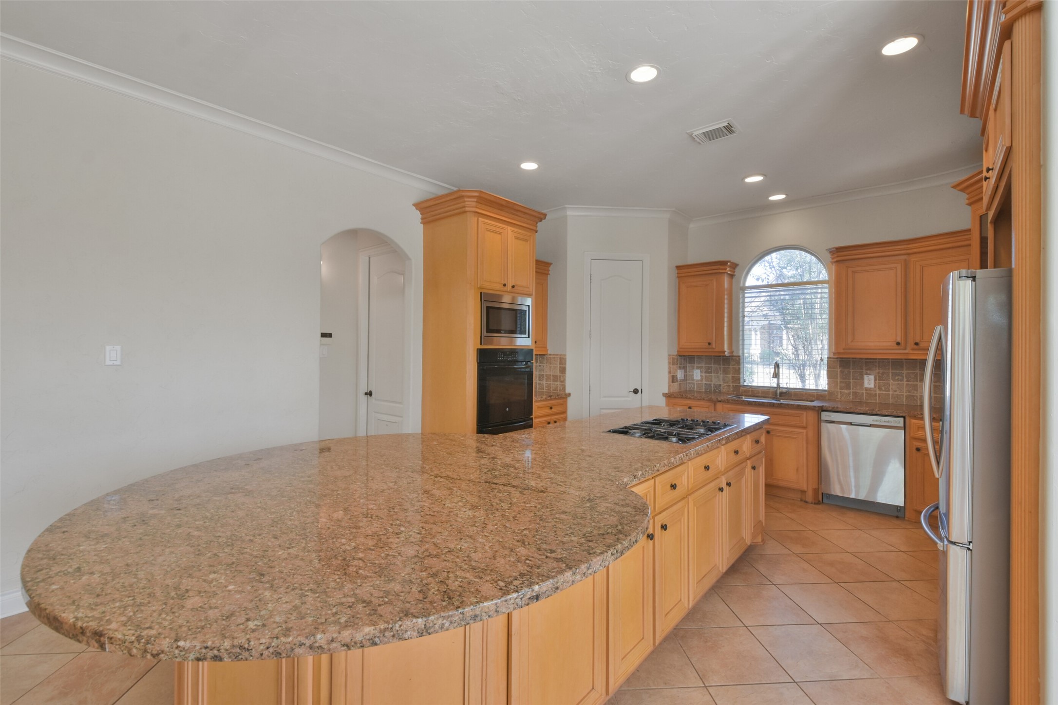 8114 Hideaway Lake Circle Spring, TX 77389 - Photo 11 of 50 a kitchen with stainless steel appliances granite countertop a sink and a refrigerator