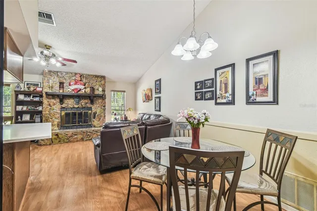 a view of a dining room with furniture wooden floor and chandelier