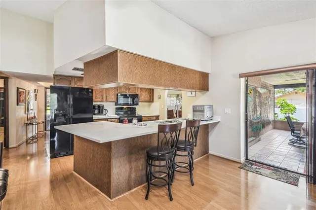 a large kitchen with a table and chairs