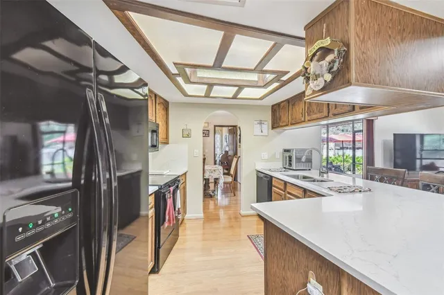 a hallway with a large window and chandelier