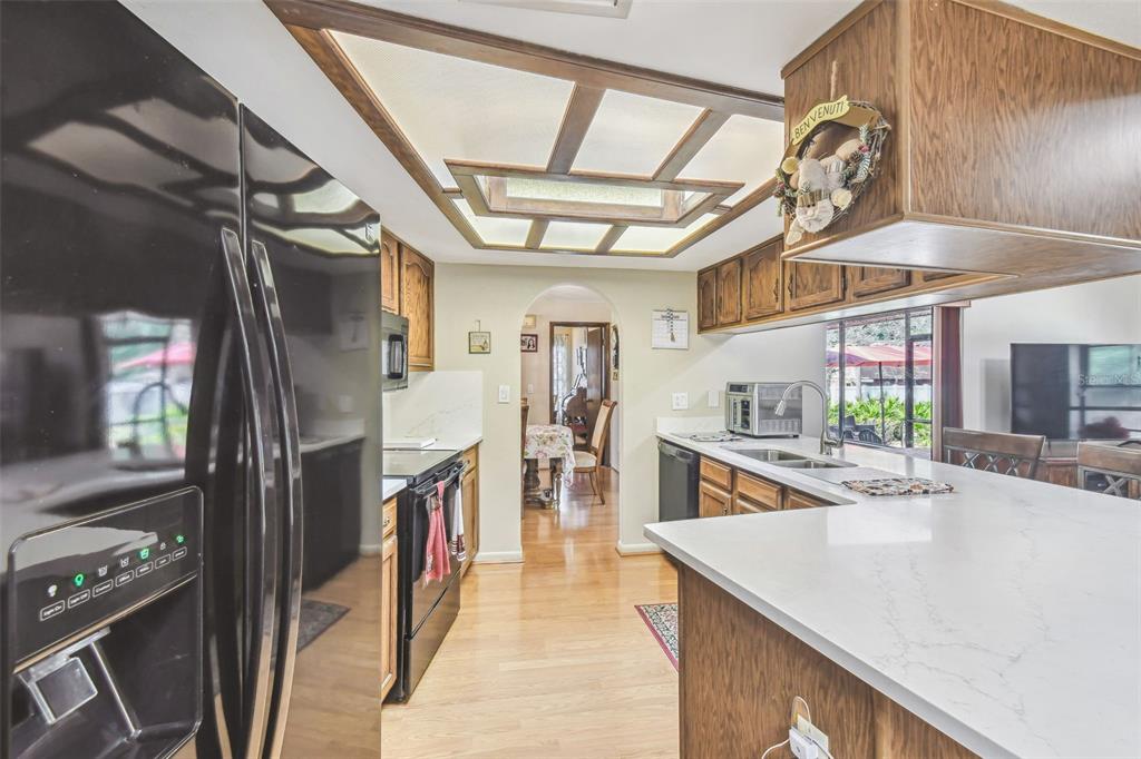 6938 Coronet Drive New Port Richey, FL 34655 - Photo 17 of 49 a hallway with a large window and chandelier