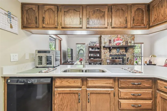 a kitchen with stainless steel appliances granite countertop a sink and cabinets