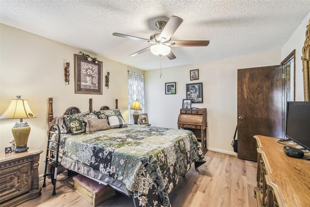 6938 Coronet Drive New Port Richey, FL 34655 - Photo 22 of 49 a bedroom with a bed and a flat screen tv