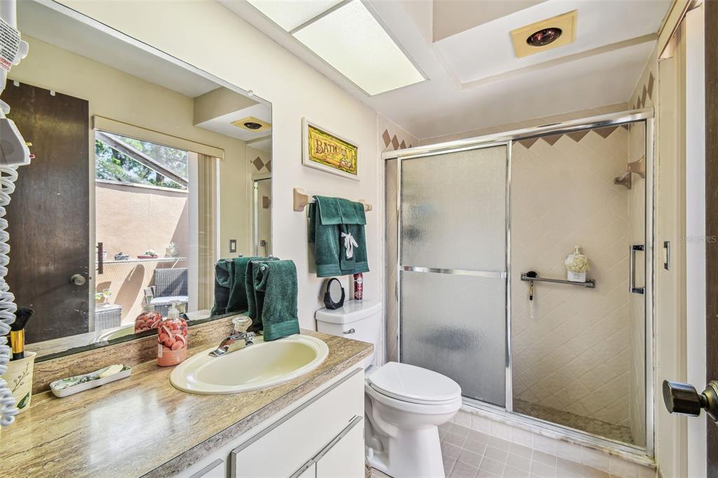 6938 Coronet Drive New Port Richey, FL 34655 - Photo 25 of 49 a bathroom with a sink a toilet and shower