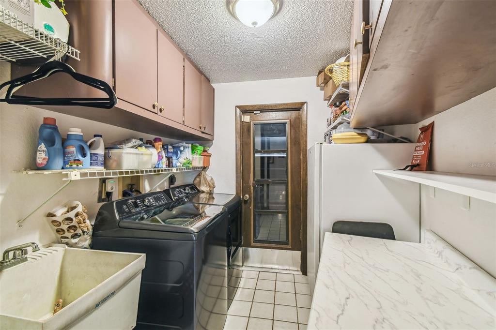 6938 Coronet Drive New Port Richey, FL 34655 - Photo 32 of 49 a kitchen that has a sink and a stove