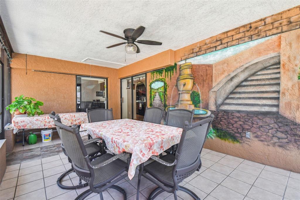 6938 Coronet Drive New Port Richey, FL 34655 - Photo 35 of 49 a view of a patio with a table and chairs