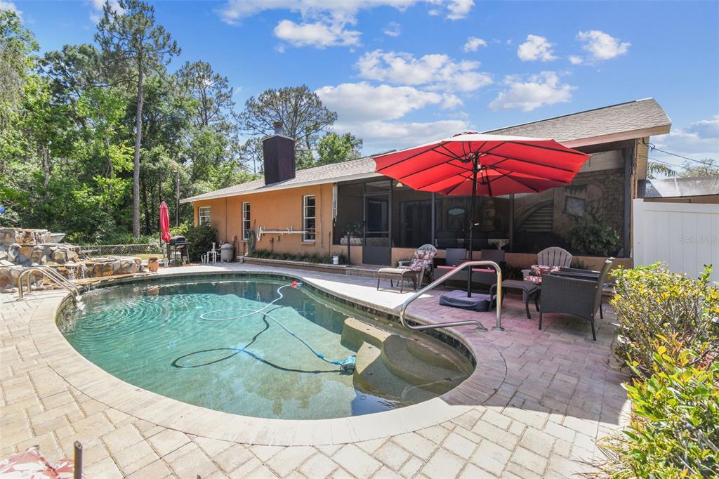 6938 Coronet Drive New Port Richey, FL 34655 - Photo 37 of 49 a view of a house with swimming pool and sitting area
