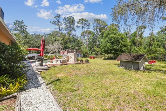 a swimming pool with outdoor seating and yard