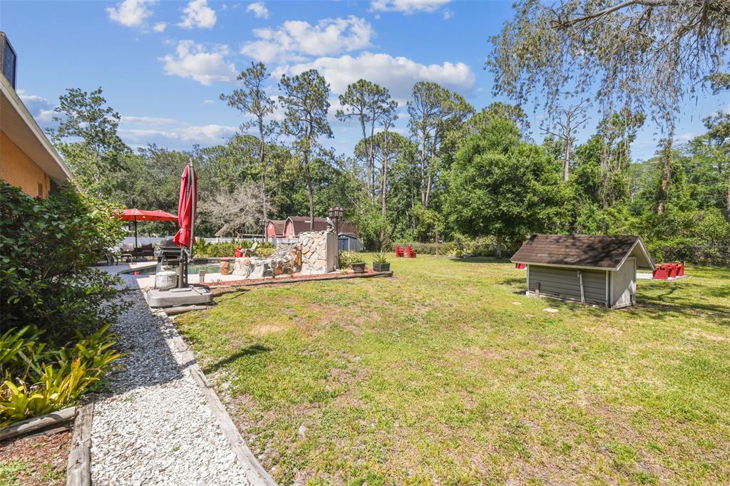 6938 Coronet Drive New Port Richey, FL 34655 - Photo 40 of 49 a swimming pool with outdoor seating and yard