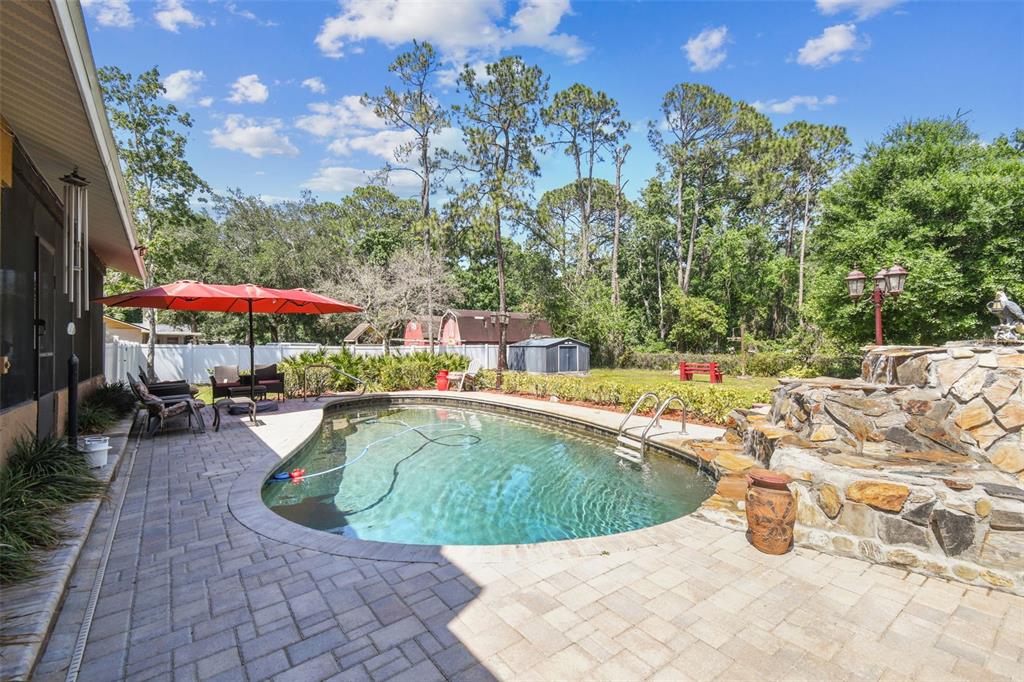 6938 Coronet Drive New Port Richey, FL 34655 - Photo 41 of 49 a view of a swimming pool with a patio