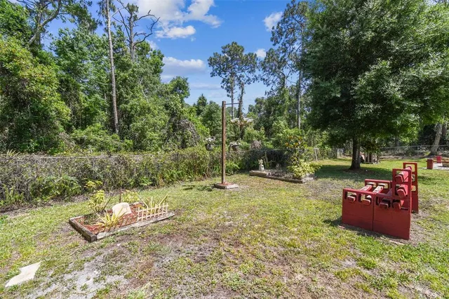 a backyard of a house with table and chairs