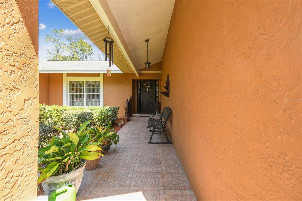 6938 Coronet Drive New Port Richey, FL 34655 - Photo 5 of 49 a hallway with a flower pot and wooden floor